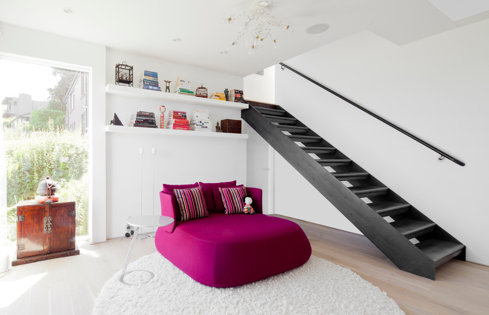 Example of a mid-sized trendy open concept light wood floor family room design in Seattle with white walls