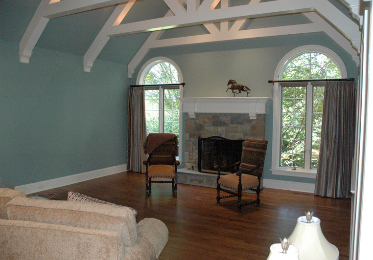 Inspiration for a medium sized traditional open plan games room in Philadelphia with a reading nook, blue walls, medium hardwood flooring, a standard fireplace and a stone fireplace surround.