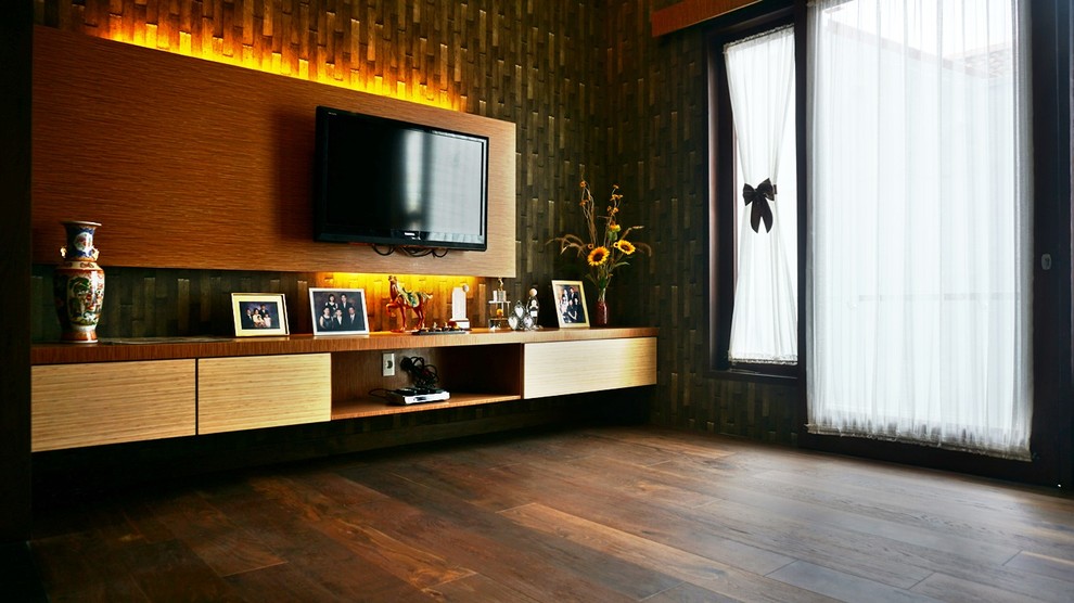 This is an example of a small world-inspired open plan games room in Other with multi-coloured walls, dark hardwood flooring, no fireplace and a wall mounted tv.
