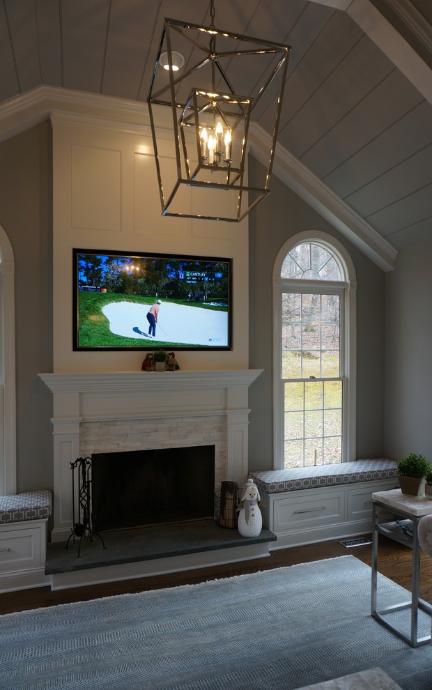 Inspiration for a mid-sized transitional open concept dark wood floor and brown floor family room remodel in Philadelphia with gray walls, a standard fireplace, a wood fireplace surround and a wall-mounted tv