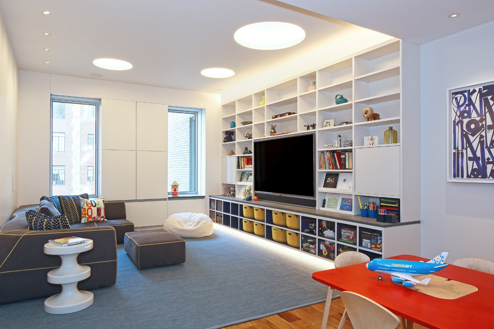 Photo of a large contemporary open plan games room in New York with white walls, no fireplace, a built-in media unit, medium hardwood flooring and brown floors.