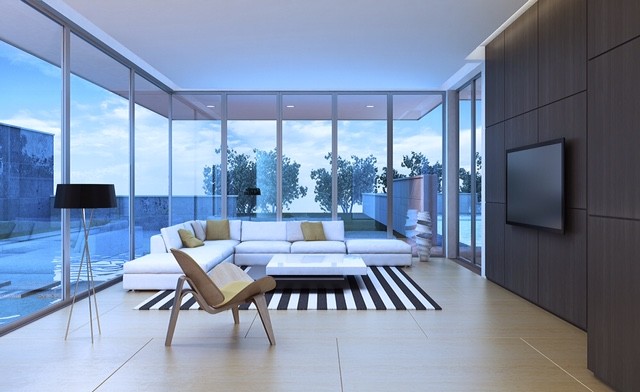 Imagen de sala de estar cerrada moderna grande sin chimenea con paredes marrones y televisor colgado en la pared