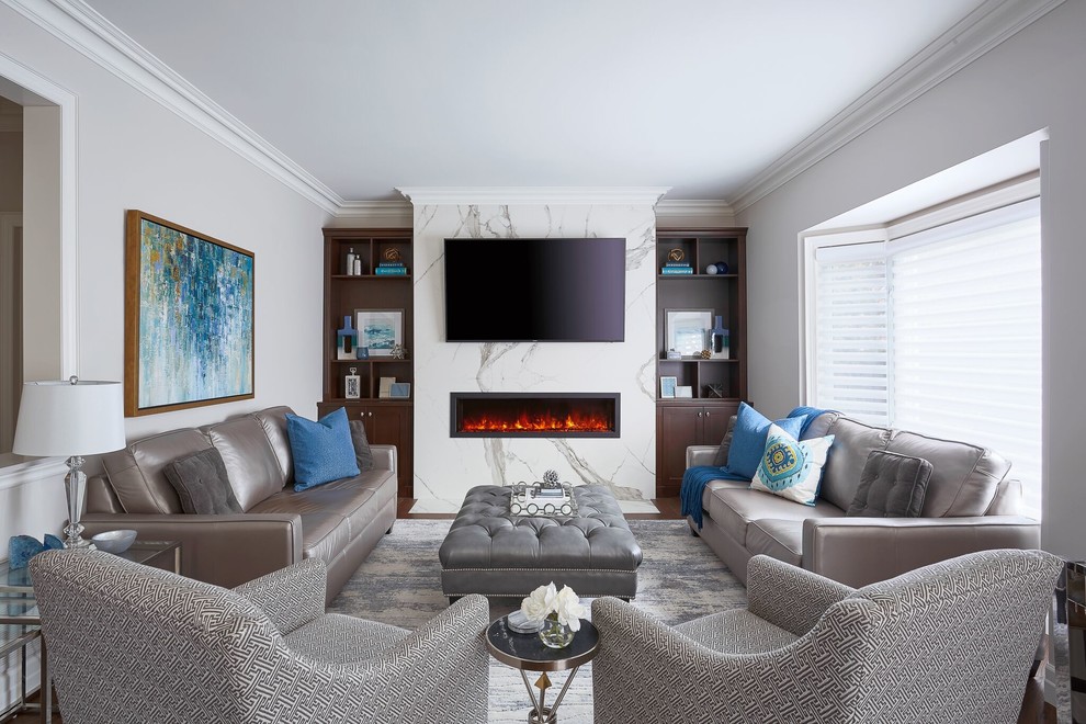 Example of a mid-sized transitional open concept medium tone wood floor and brown floor family room design in Toronto with gray walls, a hanging fireplace, a stone fireplace and a wall-mounted tv