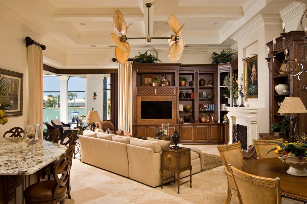 World-inspired open plan games room in Miami with beige walls, a standard fireplace and a built-in media unit.