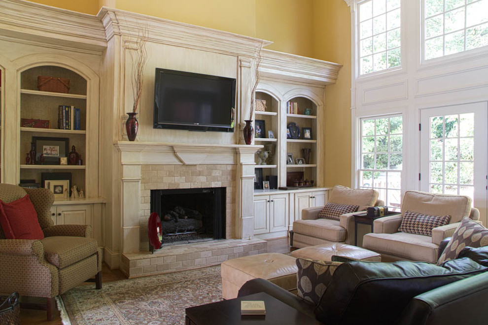This is an example of a traditional games room in Atlanta with a stone fireplace surround.