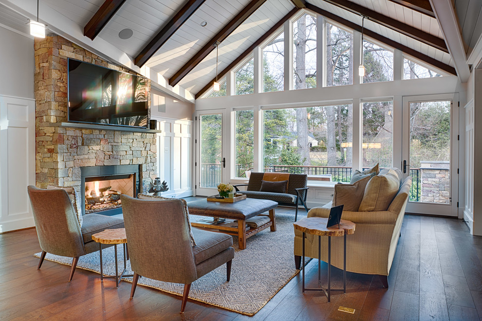 Elegant dark wood floor and brown floor family room photo in DC Metro with gray walls, a standard fireplace, a stone fireplace and a wall-mounted tv