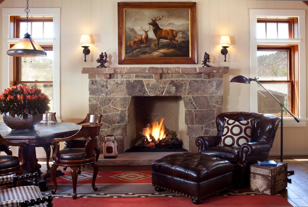 Mountain style family room photo in Denver with a stone fireplace