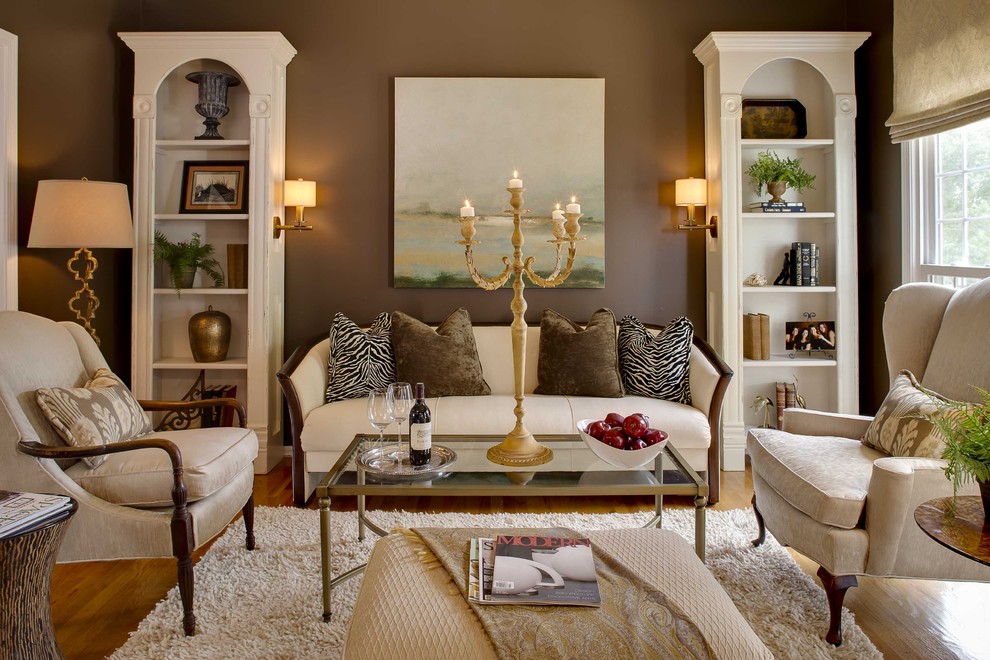 Inspiration for a timeless medium tone wood floor family room remodel in Kansas City with brown walls