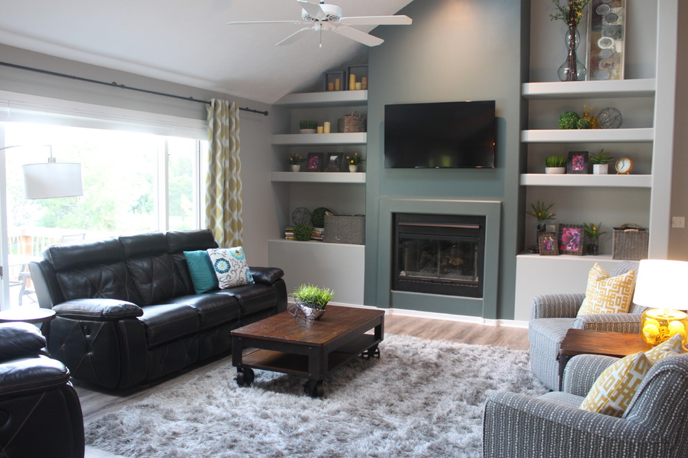 Inspiration for a medium sized contemporary open plan games room in Grand Rapids with grey walls, medium hardwood flooring, a standard fireplace, a plastered fireplace surround and a wall mounted tv.