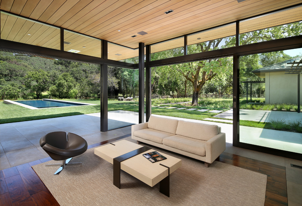 Design ideas for a contemporary open plan games room in San Francisco with dark hardwood flooring.