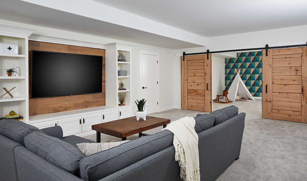 This is an example of a traditional open plan games room in Grand Rapids with white walls, carpet, a wall mounted tv and grey floors.
