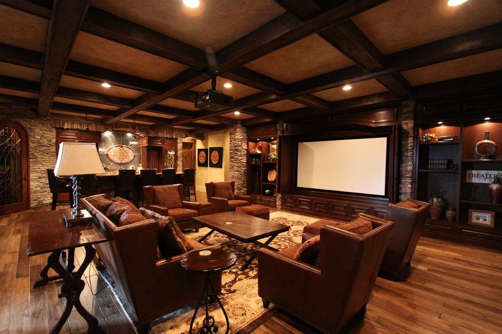 Inspiration for a large rustic open concept dark wood floor and brown floor family room remodel in Charlotte with beige walls and a media wall
