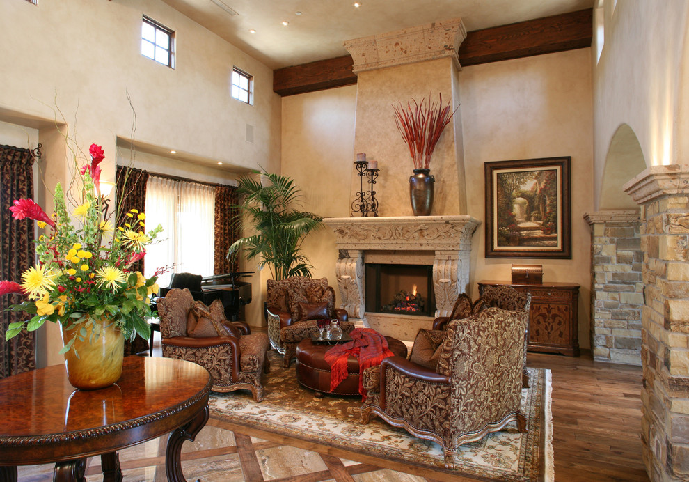 Example of a large tuscan open concept medium tone wood floor family room design in Phoenix with a stone fireplace