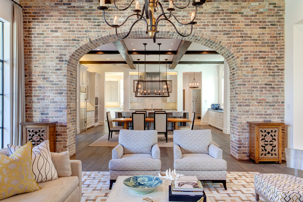 Example of a large tuscan open concept dark wood floor and brown floor family room design in Dallas with white walls, no fireplace and a wall-mounted tv