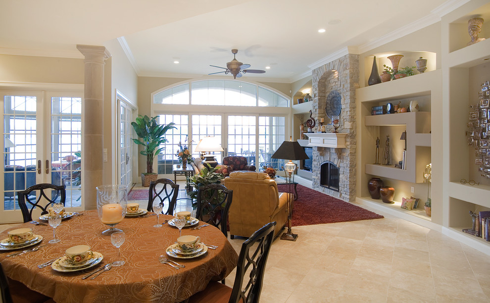 Photo of a large mediterranean open plan games room in Chicago with beige walls, ceramic flooring, a standard fireplace, a stone fireplace surround and a built-in media unit.