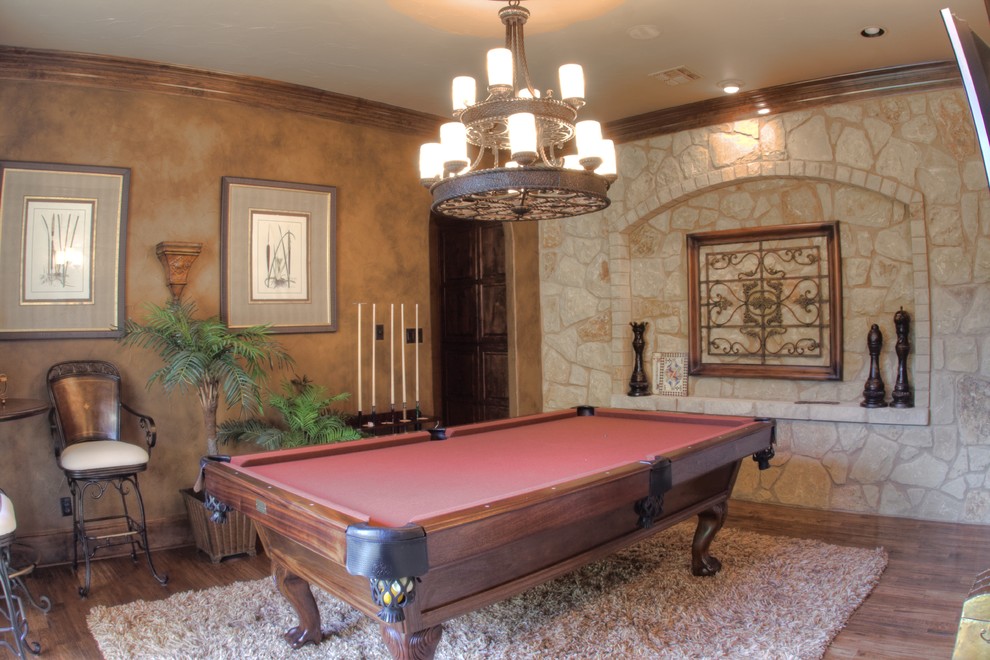 Game room - mid-sized mediterranean enclosed medium tone wood floor game room idea in Austin with brown walls, no fireplace and no tv