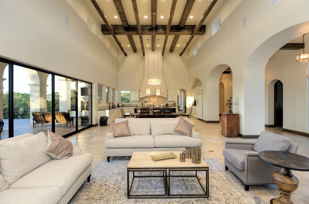 Inspiration for a large mediterranean open plan games room in Austin with beige walls and travertine flooring.