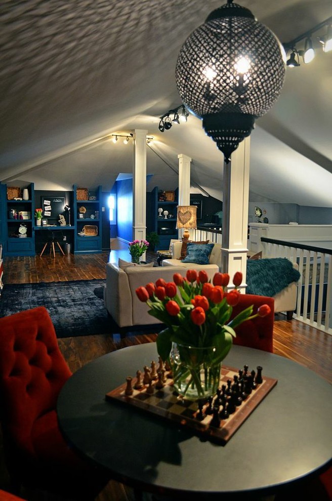 This is an example of a medium sized bohemian open plan games room in Atlanta with a reading nook, blue walls, laminate floors, no fireplace and a freestanding tv.