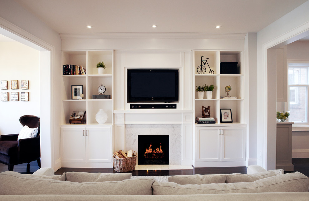 Classic games room in Toronto with dark hardwood flooring, a standard fireplace and a wall mounted tv.