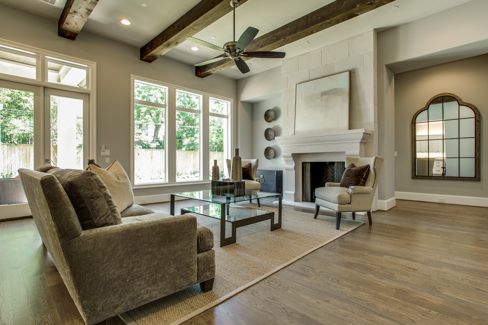 Großes, Offenes Klassisches Wohnzimmer mit grauer Wandfarbe, braunem Holzboden, Kamin und Kaminumrandung aus Stein in Houston