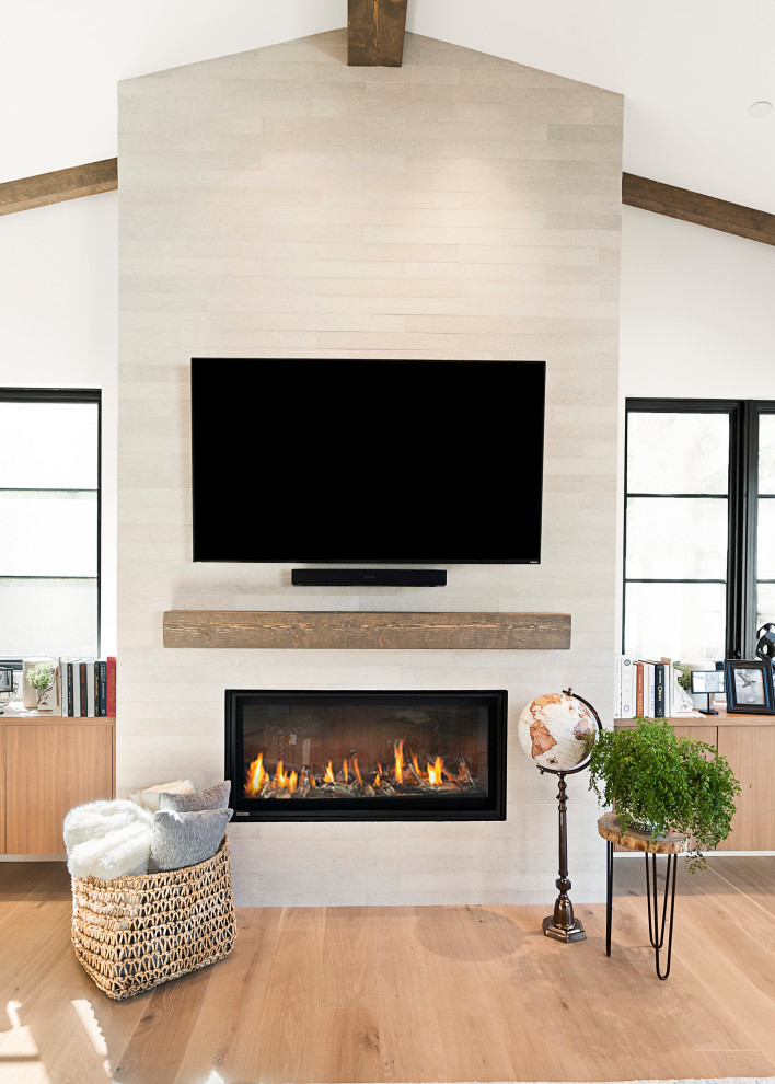 Mid-sized farmhouse enclosed light wood floor and brown floor family room photo in San Francisco with white walls, a standard fireplace, a tile fireplace and a wall-mounted tv
