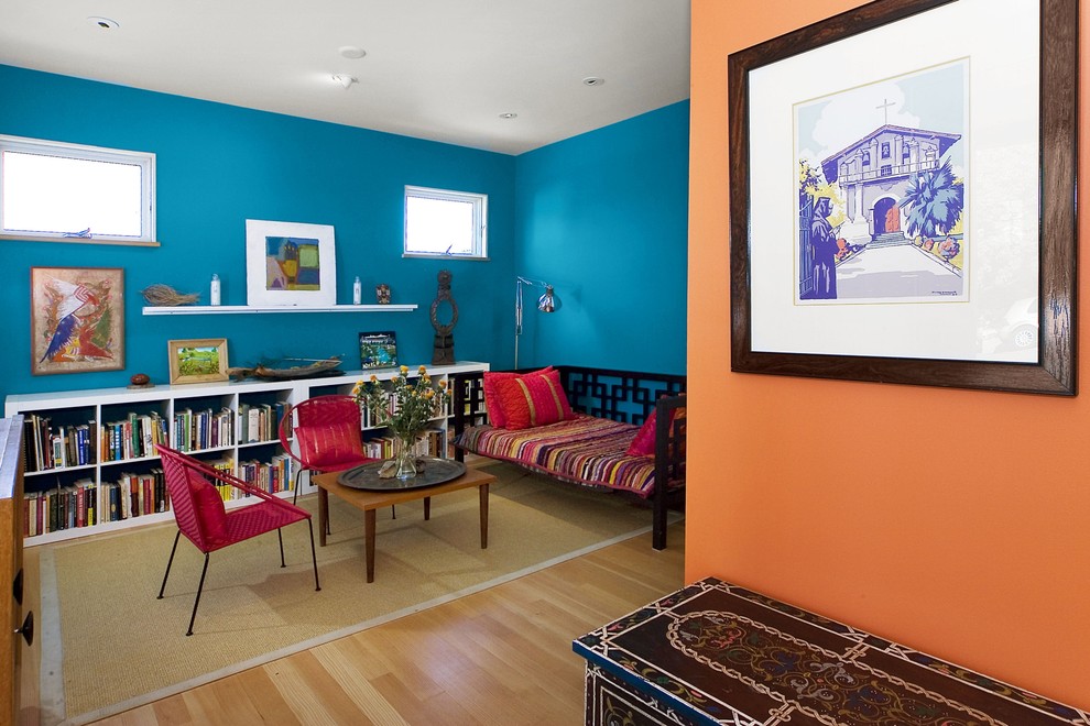 Family room - contemporary medium tone wood floor and beige floor family room idea in San Francisco with blue walls