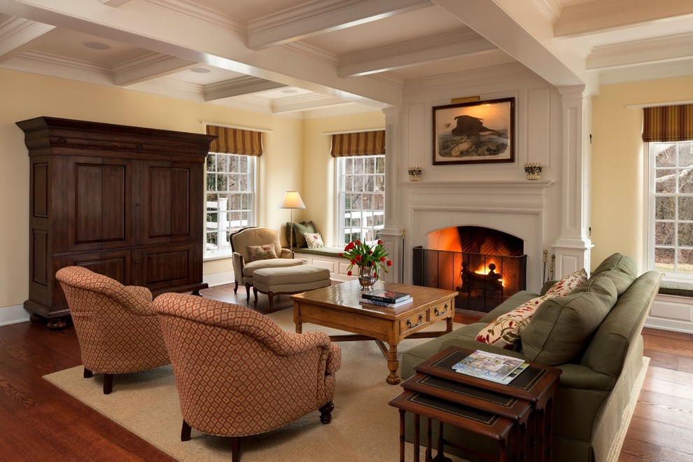 Idée de décoration pour une salle de séjour tradition avec un mur beige, parquet foncé et une cheminée standard.