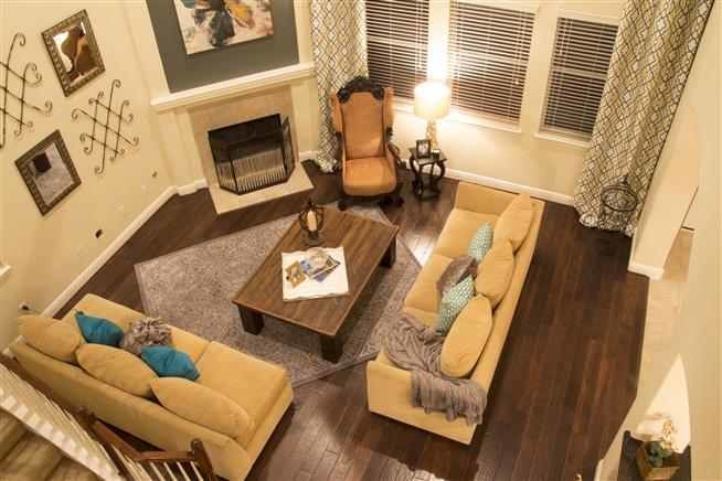 Example of a mid-sized transitional open concept dark wood floor family room design in Houston with beige walls, a corner fireplace, a tile fireplace and no tv