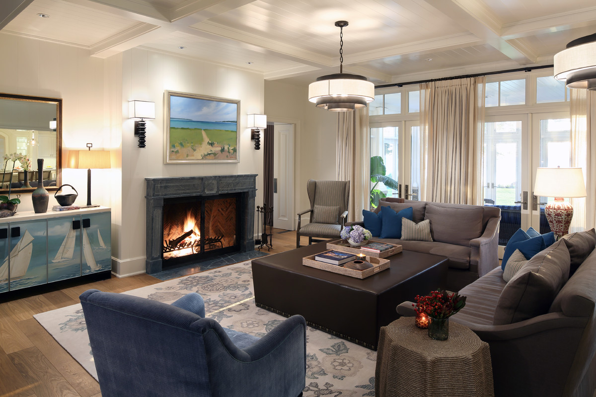 Design ideas for a large beach style open plan games room in Grand Rapids with white walls, medium hardwood flooring, a standard fireplace, a stone fireplace surround and brown floors.