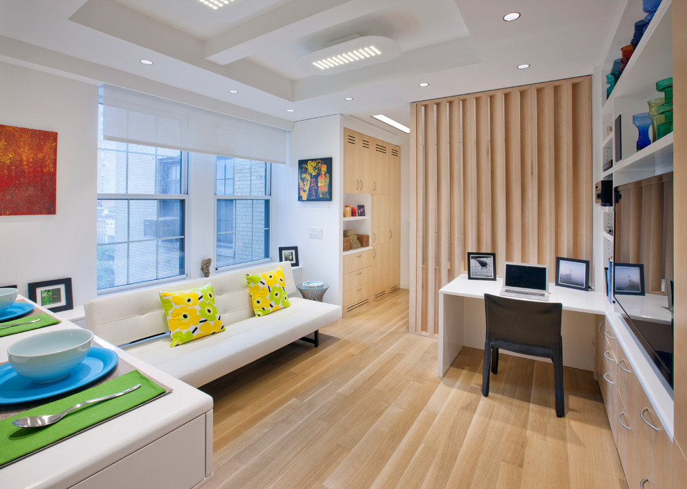 Family room - small scandinavian open concept light wood floor and white floor family room idea in New York with white walls, no fireplace and a tv stand