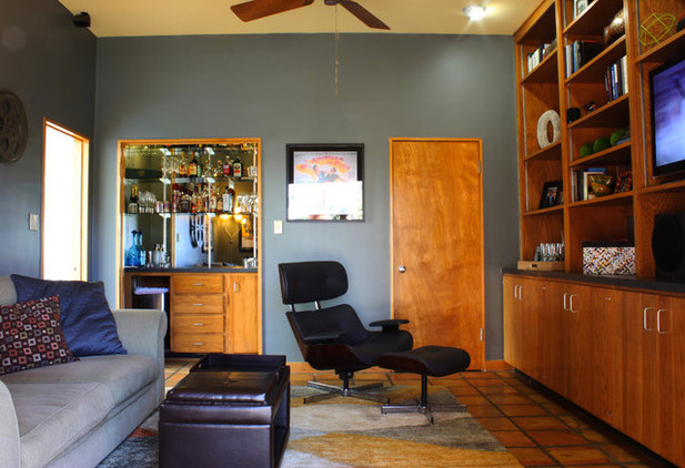 This is an example of a medium sized midcentury enclosed games room in New Orleans with grey walls, terracotta flooring, a built-in media unit and brown floors.