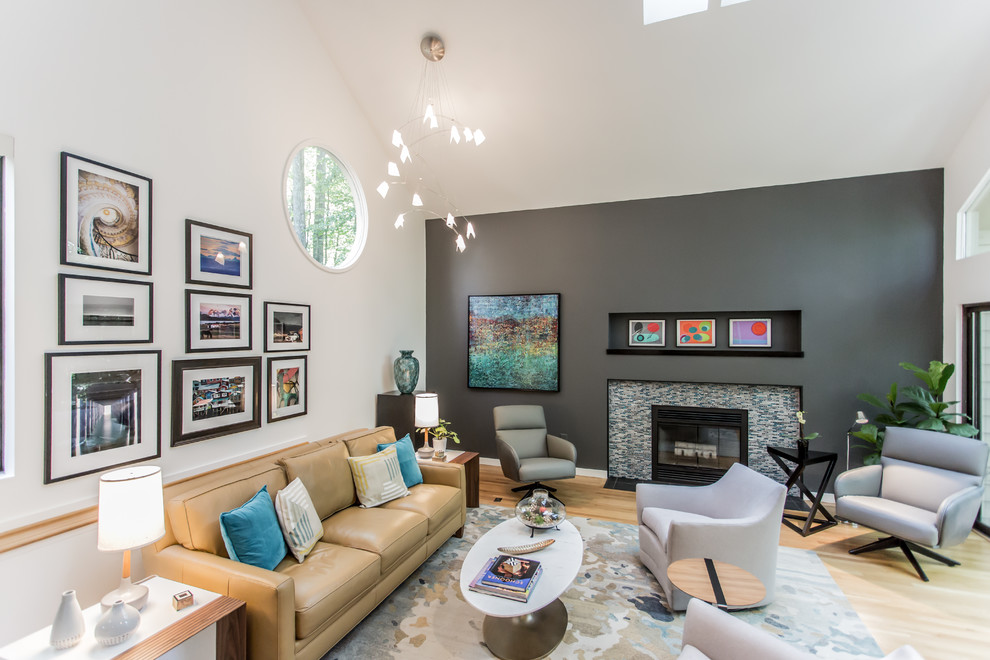 Photo of a medium sized retro open plan games room in DC Metro with white walls, light hardwood flooring, a standard fireplace, a tiled fireplace surround, a concealed tv and yellow floors.