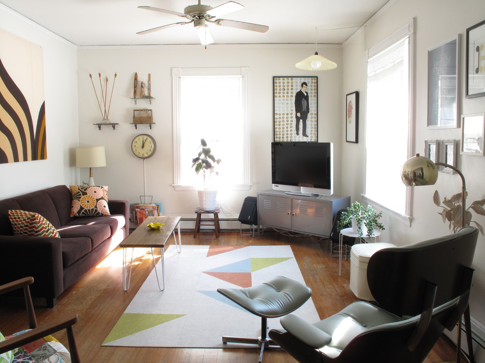 Family room - mid-sized eclectic family room idea in Boston with white walls, no fireplace and a tv stand