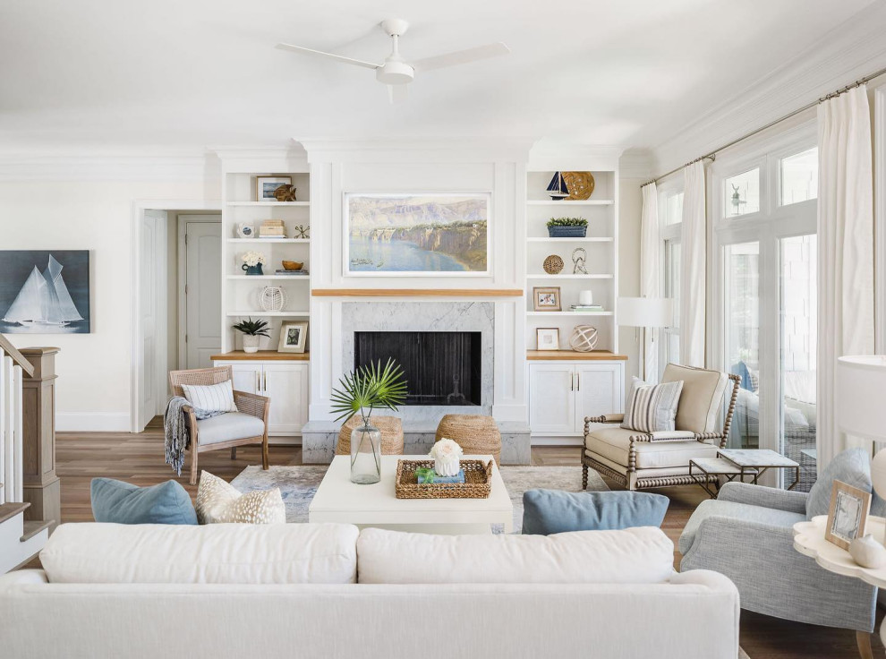 Inspiration for a large nautical games room in Charlotte with white walls, light hardwood flooring, a standard fireplace, a stone fireplace surround, a wall mounted tv and beige floors.