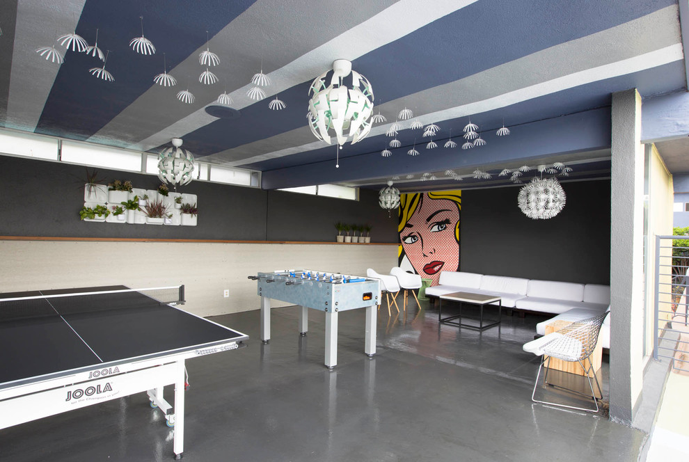 Design ideas for a contemporary open plan games room in Los Angeles with a game room, grey walls and concrete flooring.