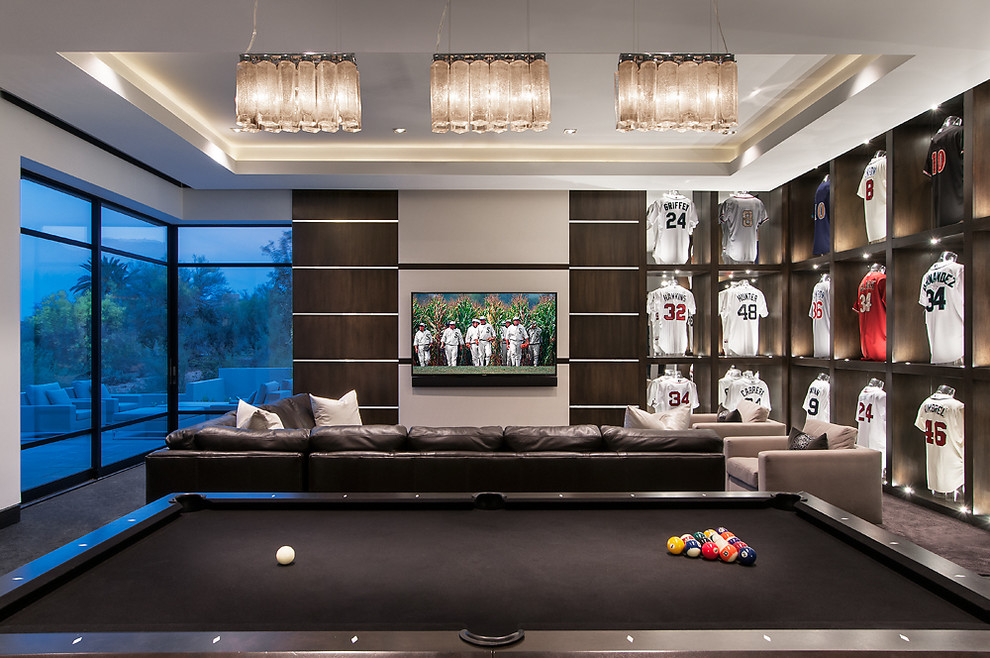 Immagine di un soggiorno minimal con sala giochi e TV a parete