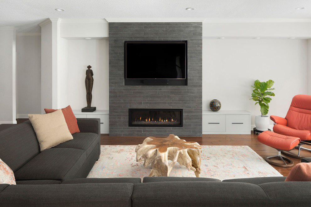Design ideas for a contemporary open plan games room in Minneapolis with medium hardwood flooring, a tiled fireplace surround, a built-in media unit, white walls and a ribbon fireplace.