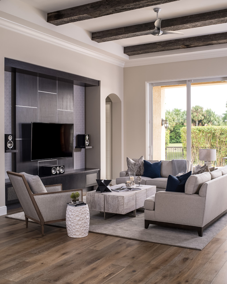 Inspiration for a medium sized traditional open plan games room in Miami with beige walls, medium hardwood flooring, no fireplace, a wall mounted tv and brown floors.