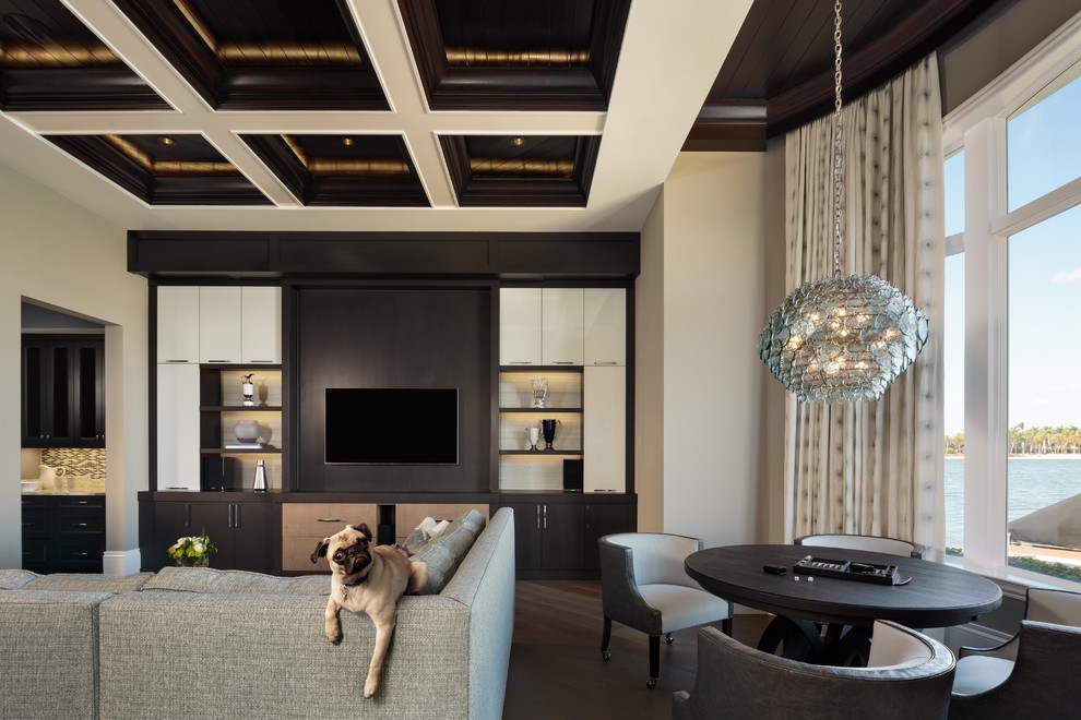 Inspiration pour une salle de séjour traditionnelle avec un mur beige, parquet foncé, un téléviseur encastré et un sol marron.