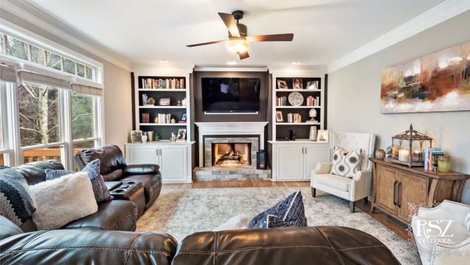This is an example of a medium sized classic open plan games room in Other with grey walls, medium hardwood flooring, a standard fireplace, a tiled fireplace surround and a wall mounted tv.
