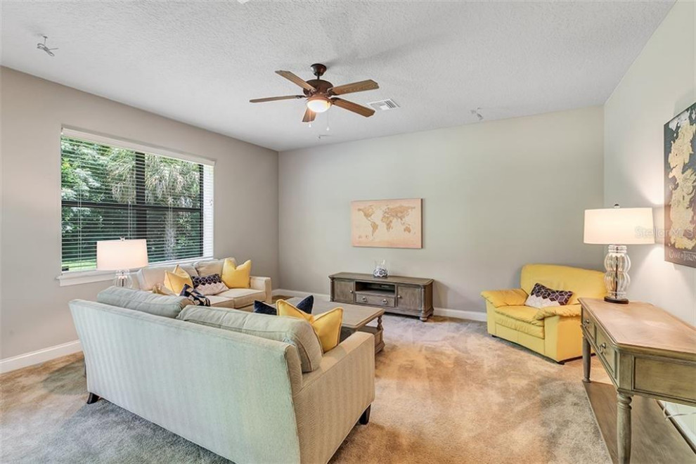 Example of a large classic open concept beige floor and carpeted family room design in Orlando with gray walls and no fireplace