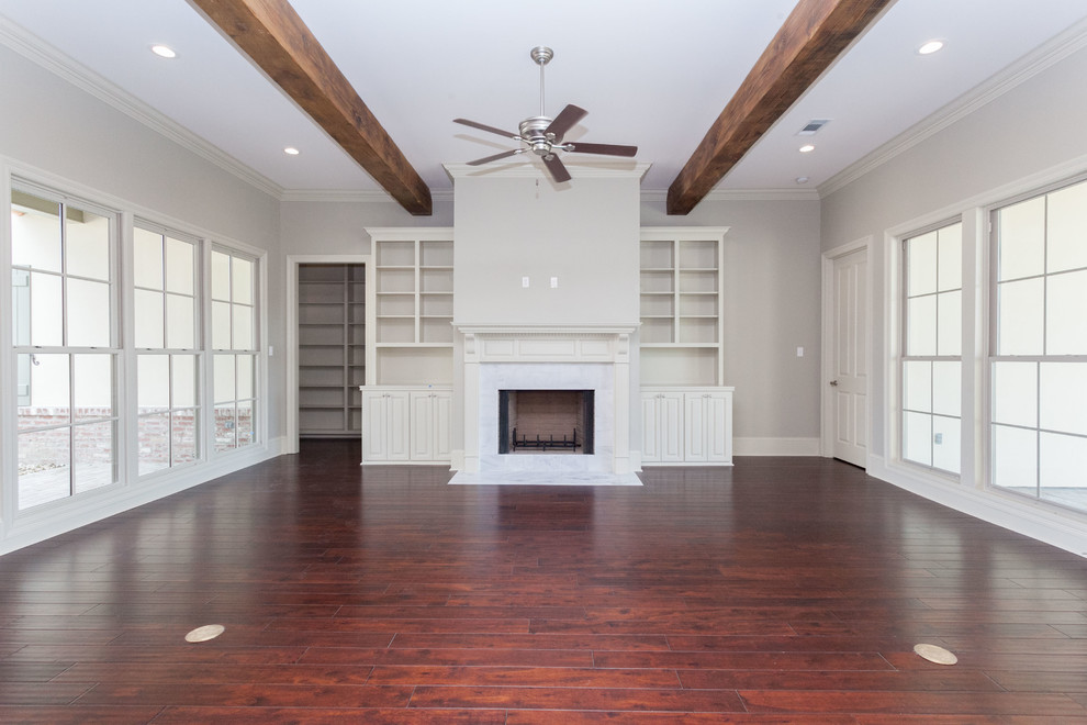 Inspiration for a medium sized classic open plan games room in New Orleans with grey walls, dark hardwood flooring, a standard fireplace and a stone fireplace surround.