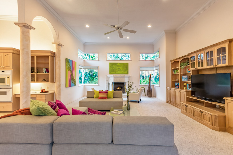 This is an example of a contemporary games room in Tampa with beige walls, carpet and beige floors.
