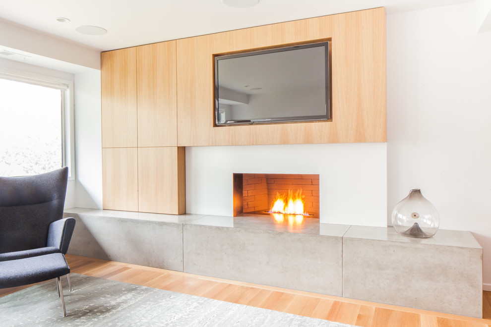 Minimalist open concept light wood floor family room photo in Portland with white walls, a ribbon fireplace and a media wall