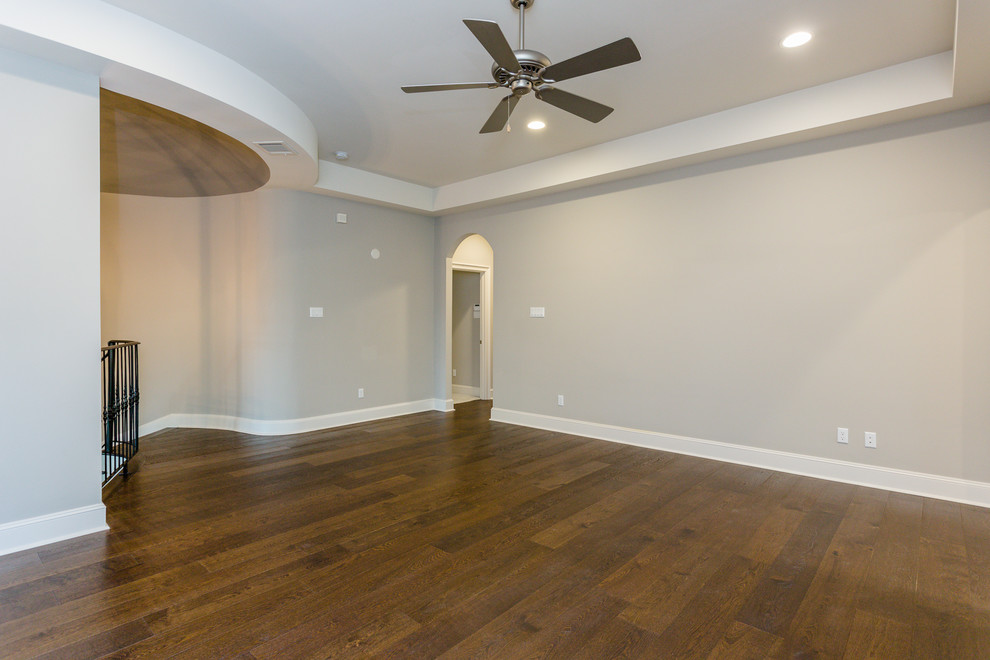 Large trendy loft-style dark wood floor and brown floor game room photo in Houston with gray walls and a media wall