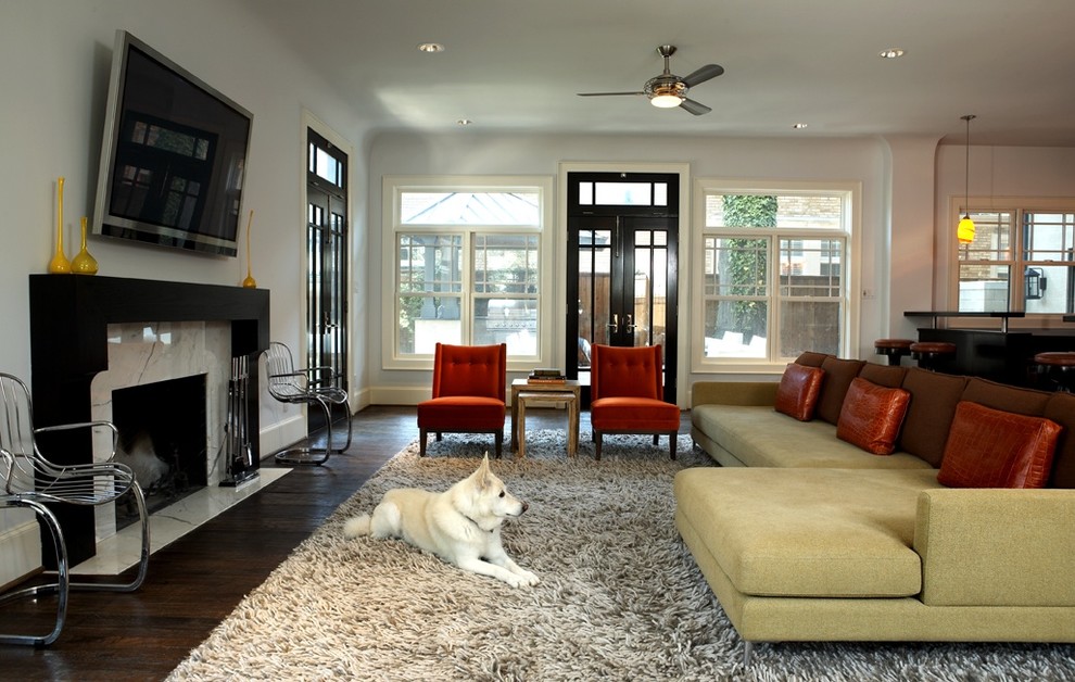 Photo of a contemporary games room in Seattle with dark hardwood flooring, a standard fireplace, a stone fireplace surround, a wall mounted tv and grey walls.