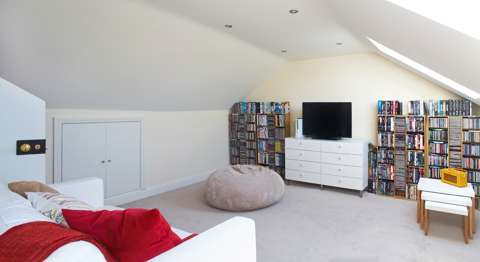 This is an example of a contemporary enclosed games room in Dublin with beige walls and carpet.