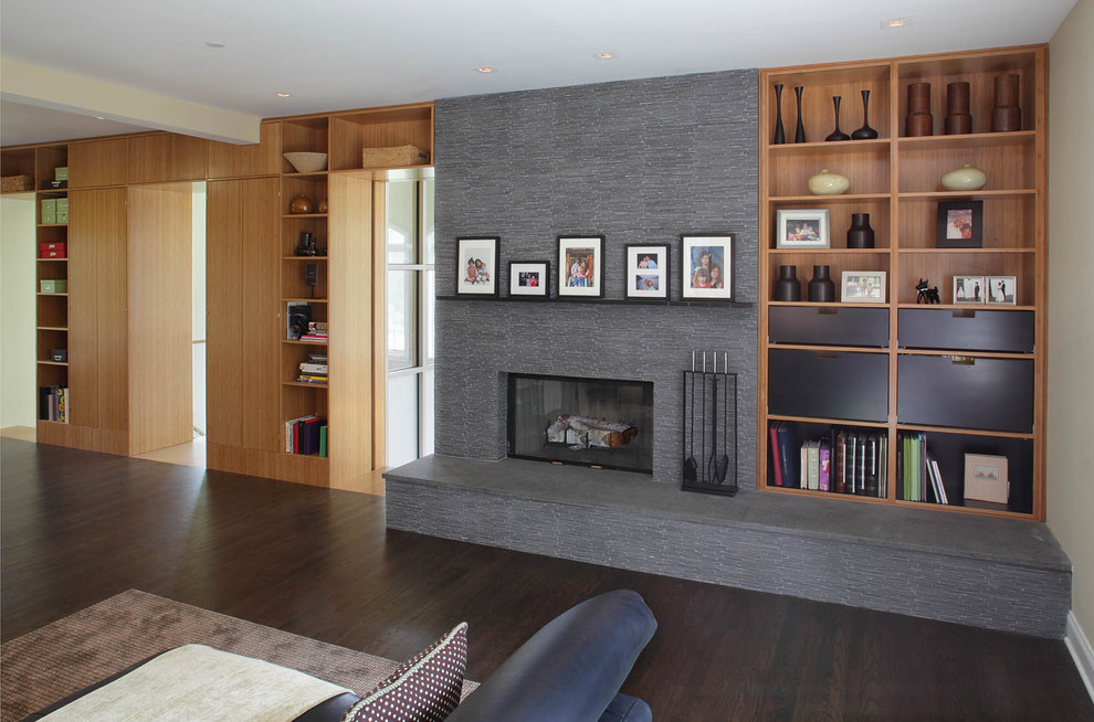 Trendy family room photo in New York with beige walls, a standard fireplace and a stone fireplace