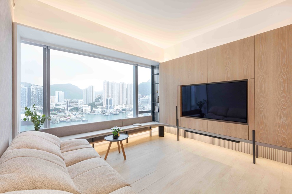 Modern enclosed games room in Hong Kong with white walls, light hardwood flooring and a built-in media unit.