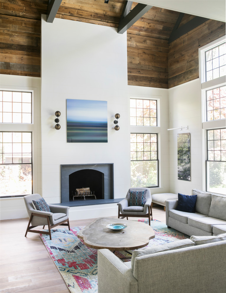 Farmhouse open concept light wood floor and beige floor family room photo in New York with white walls and a standard fireplace